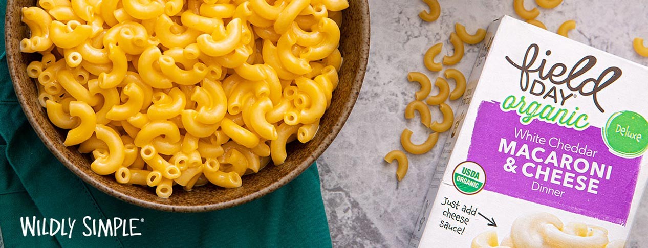 Field Day Organic Mac and Cheese box next to a bowl of macaroni